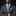 Man wearing a gray suit with a patterned tie and pocket square on a black background