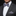 Man wearing a gray suit with a patterned bow tie and pocket square on a black background