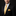 Man wearing a black suit with a yellow tie and pocket square on a black background