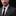 Man wearing a suit with a ribbon pin on a black background