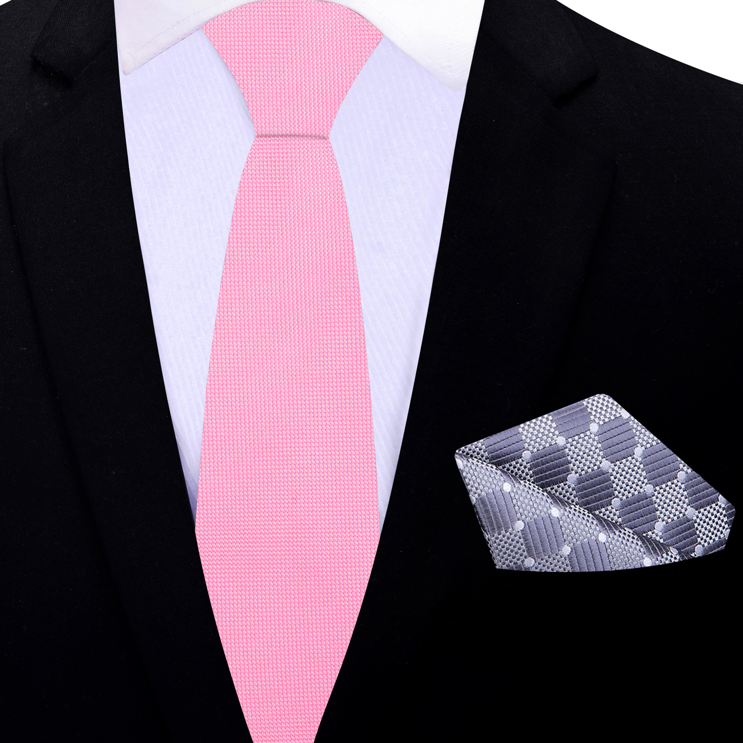 Pink thin tie and patterned pocket square on a black suit jacket.