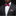 Man wearing a black suit with a white shirt, red bow tie, and plaid pocket square on a black background.