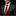 Man wearing a dark suit with a red tie and patterned pocket square on a black background
