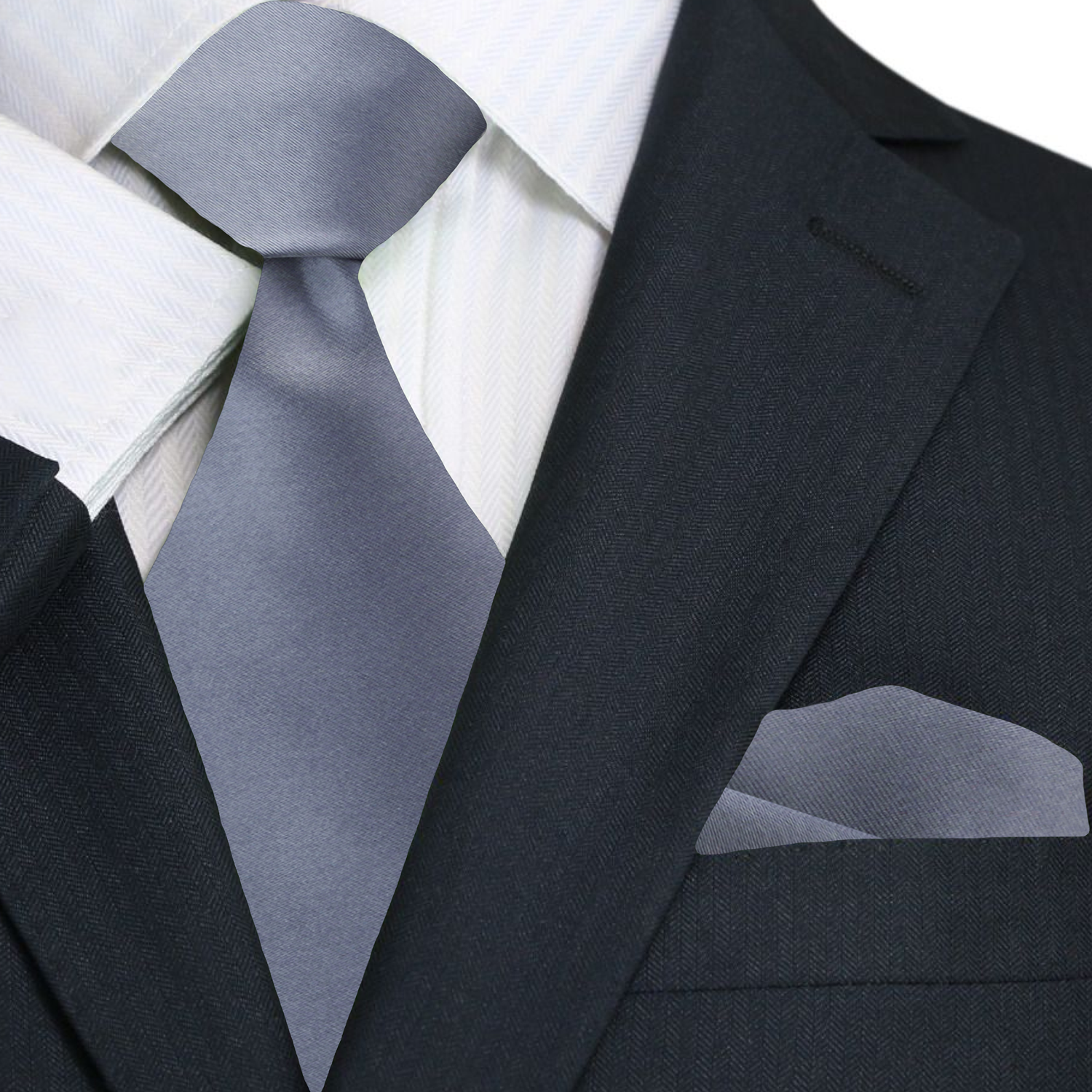 Black suit with white shirt, gray tie, and matching pocket square on a white background