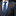 Gray suit with a blue tie and pocket square on a black background