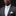 Man wearing a gray suit with a white shirt and pocket square on a black background