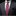 Gray suit with a red paisley tie and accenting pocket square on a black background