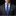 Man wearing a gray suit with a blue tie and pocket square on a black background