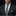 Man wearing a dark suit with a green tie and pocket square against a black background