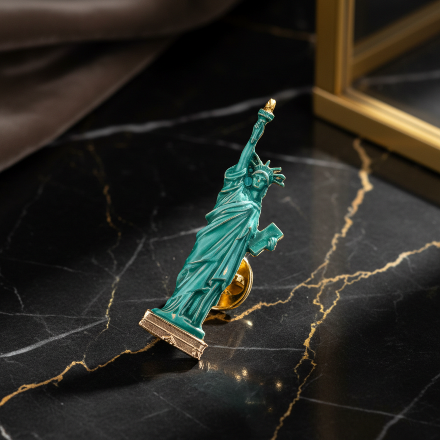 A miniature Statue of Liberty figurine, styled in a glossy turquoise green with gold accents on the torch and base, resting 