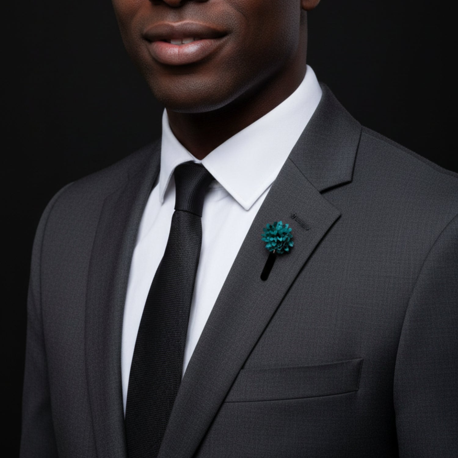 Teal flower-shaped lapel pin on a black background
