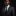 Man wearing a dark suit with a white shirt and black tie on a black background
