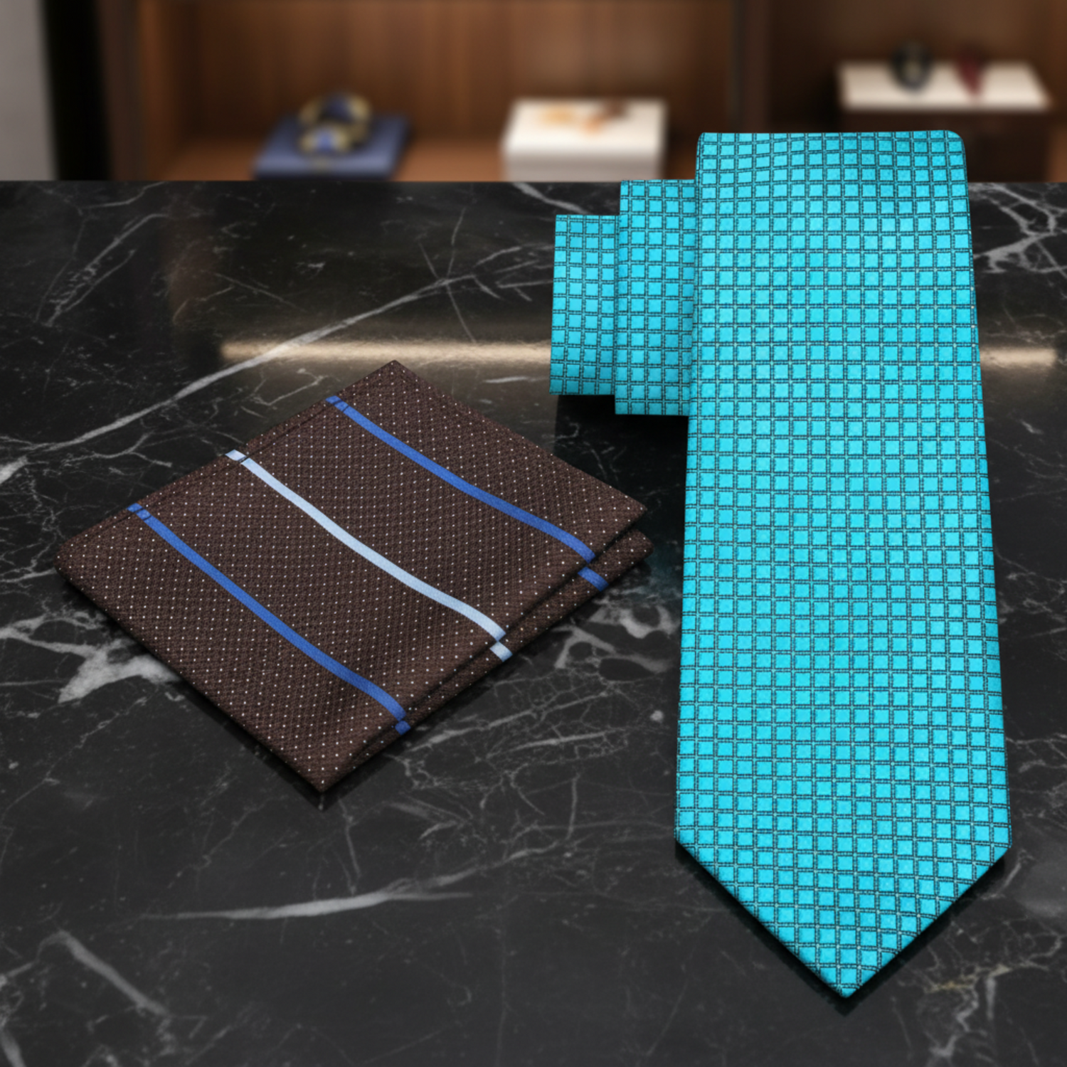 A men's necktie and matching pocket square set on a plain white background. The necktie is bright turquoise blue with a textured grid pattern, and the matching pocket square is dark brown with small white dots and diagonal blue and white stripes.