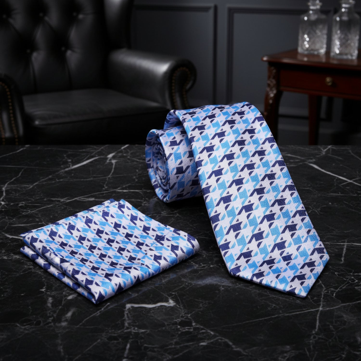 White, blue houndstooth tie and matching square on black marble