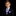 A young boy wearing a formal black suit, white dress shirt, a purple and white checkered tie, and a matching pocket square, photographed against a solid black background.