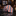 Rolled-up checkered tie on a marble surface with a clothing store background