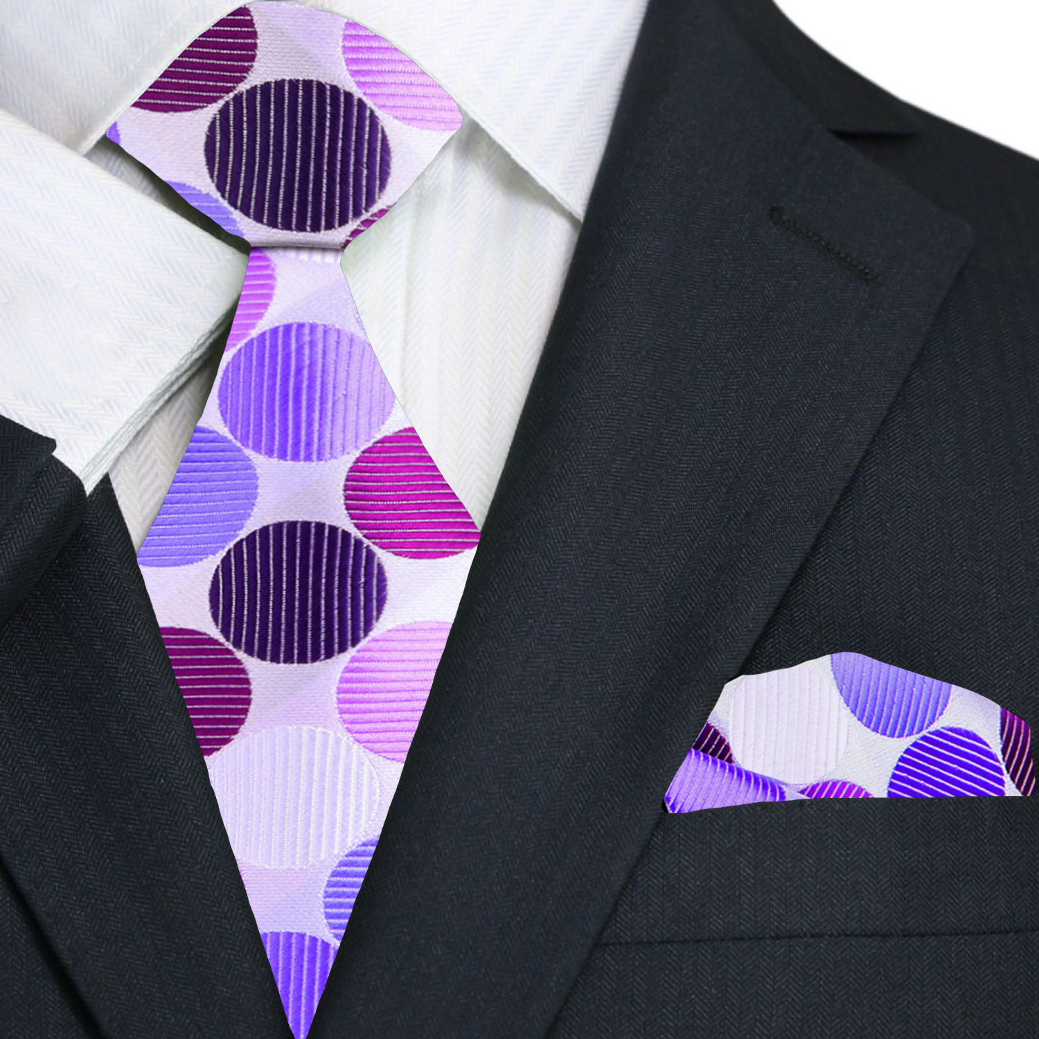 Black suit with a purple and white polka dot tie and pocket square.