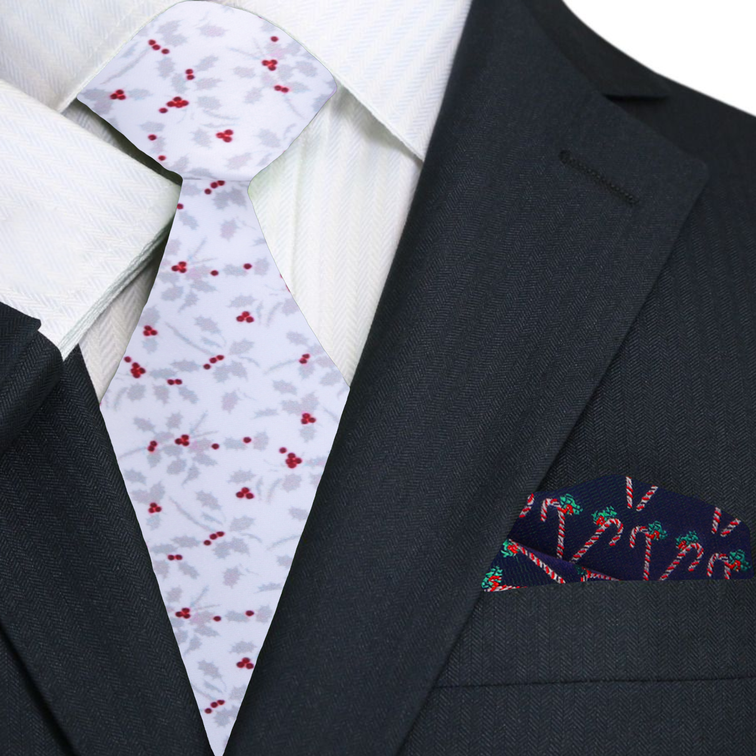 Black suit with a white shirt, patterned tie, and embroidered pocket square.