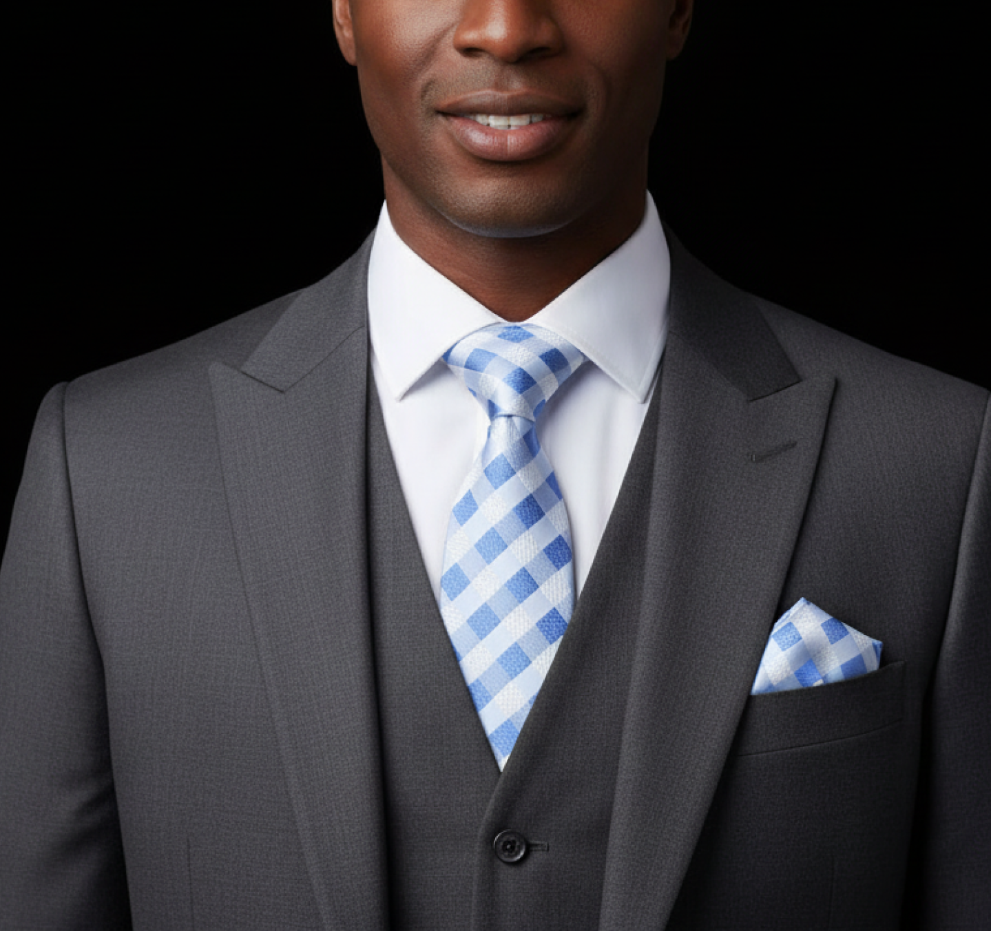 Man wearing a gray suit with a  Blue, White Check Tie and Square