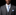 Man wearing a gray suit with a  Blue, White Check Tie and Square