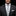 Man wearing a dark suit with a striped tie and pocket square on a black background
