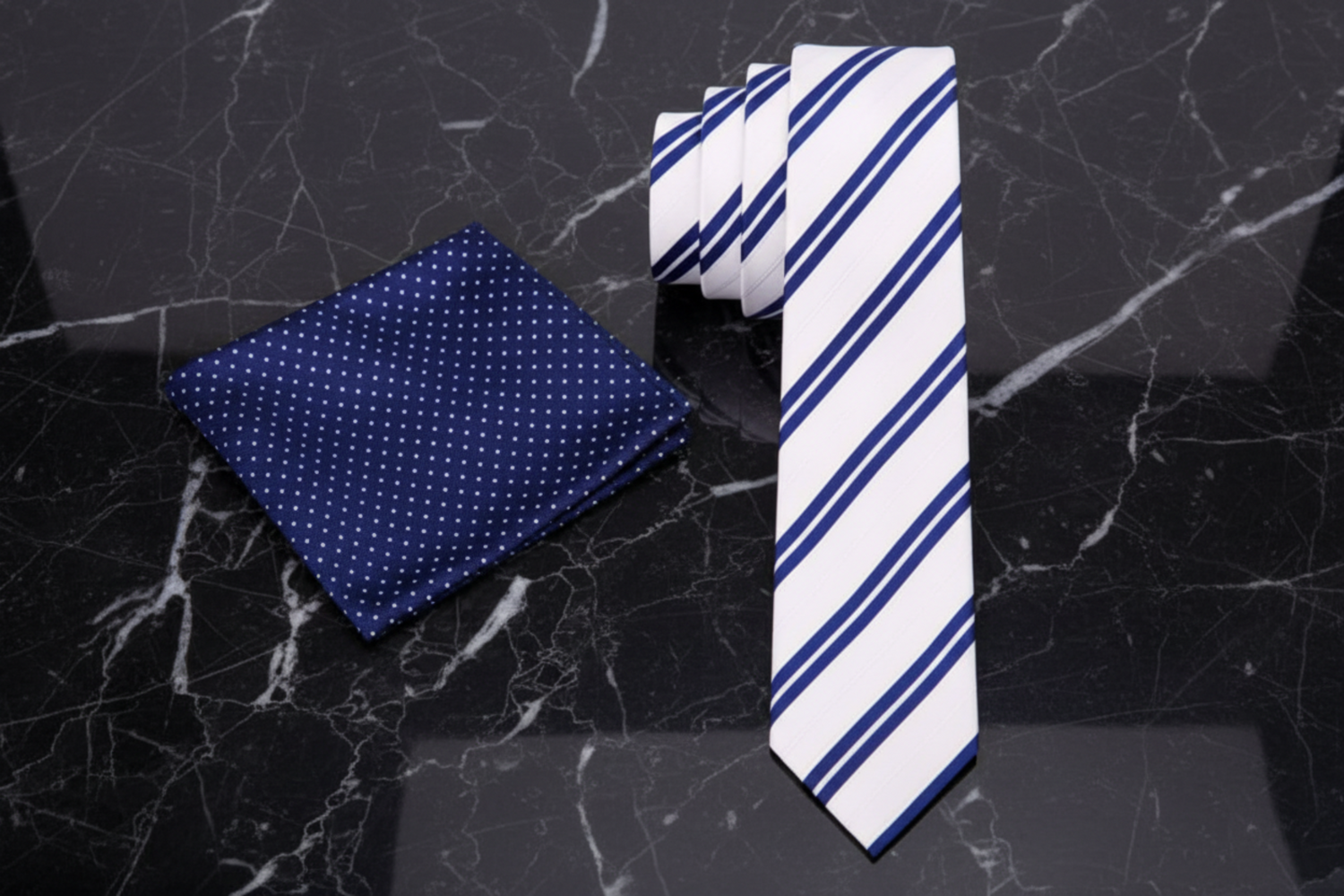 Navy pocket square with white polka dots and a striped tie 