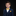 Young boy in a navy suit with a yellow bow tie and pocket square on a black background