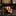 Roll of yellow and blue striped tie on a dark surface with a blurred background