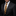 A man wearing a dark charcoal gray suit jacket, white dress shirt, a yellow and navy striped necktie, and a matching navy pocket square with gold dots, set against a solid black background.