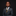 Young boy in a formal suit with a tie and pocket square on a black background