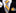 Yellow and gray striped tie with matching pocket square and cufflinks on a black suit.