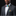Man wearing a gray suit with colorful bow tie and pocket square against a black background