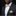 Man wearing a black suit with a yellow bow tie and pocket square against a black background