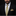 Man wearing a black suit with a yellow patterned tie and pocket square on a black background