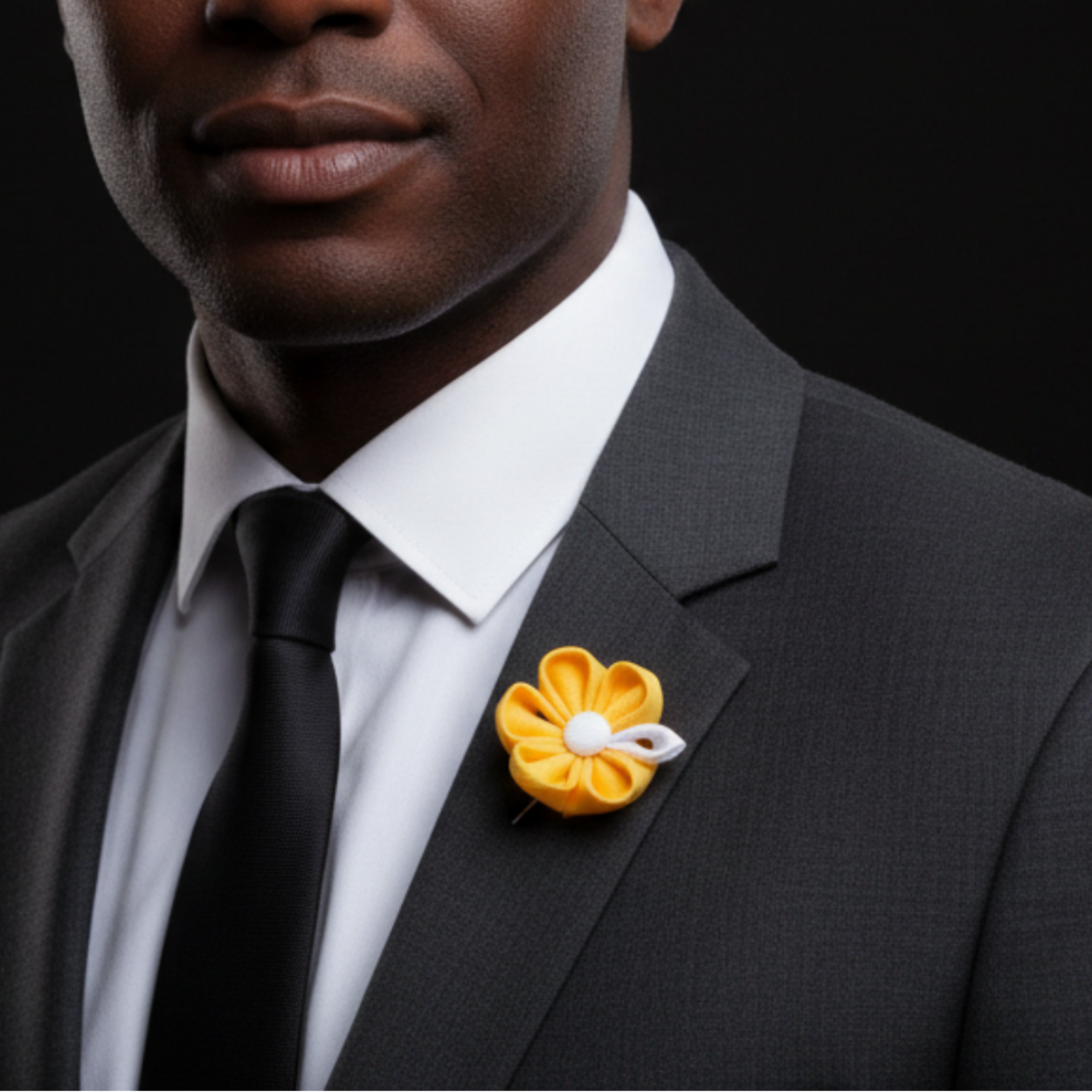 yellow flower brooch on man with grey suit
