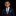 Young boy in a dark suit with a blue tie on a black background