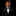 Young boy in a formal black suit with gold bow tie and pocket square on a black background