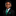 Young boy in a black suit with a green tie and pocket square on a black background