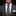 Man wearing a dark gray suit with a colorful floral tie and white pocket square on a black background