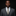 Man wearing a gray suit with a striped tie against a black background
