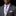 Man wearing a gray suit with a purple tie and pocket square on a black background