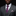 Man wearing a gray suit with a purple tie and pocket square on a black background