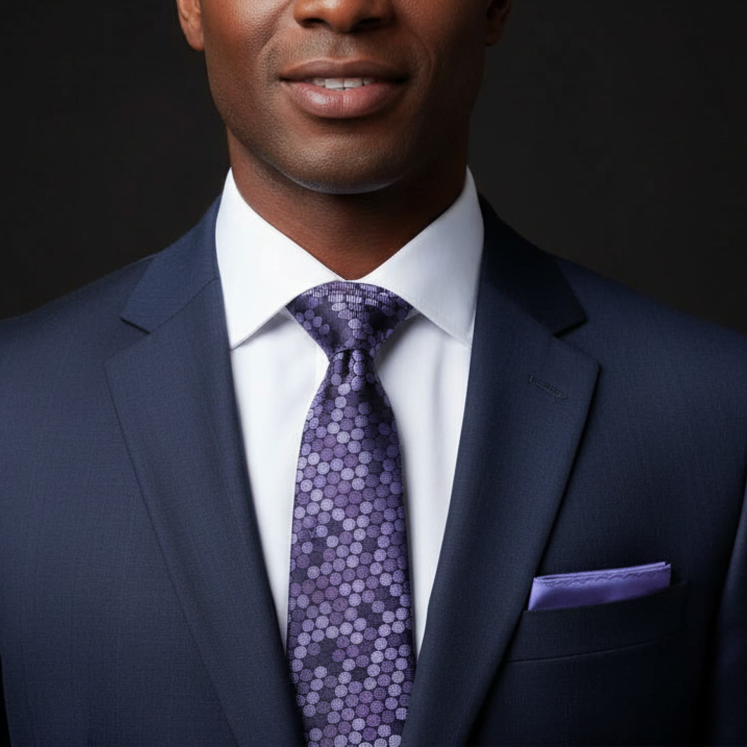 purple polka patterned tie and accenting square on man
