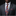Man wearing a gray suit with a colorful tie and pocket square against a black background