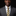 Man wearing a gray suit with a yellow and blue striped tie against a dark background