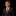 Young boy in a black suit with a red tie and pocket square on a black background