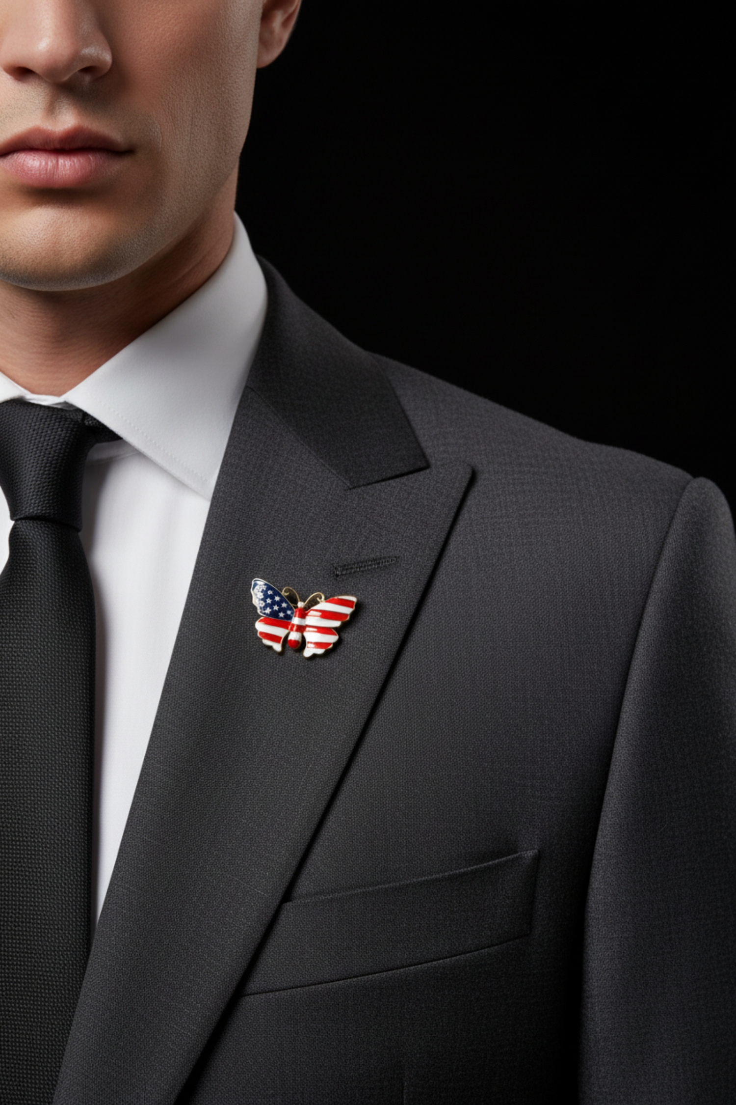 A butterfly-shaped enamel pin featuring an American flag design with red and white stripes and a blue wing with white stars, outlined in gold metal, shown on man