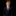 Young boy in a formal black suit with a patterned tie on a black background