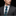 Man wearing a gray suit with a patterned blue tie against a black background