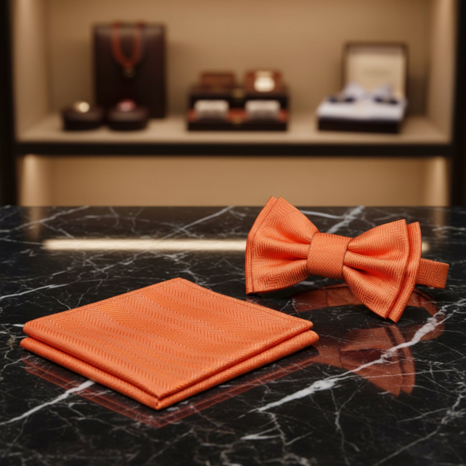 Orange bow tie and matching pocket square on a white background